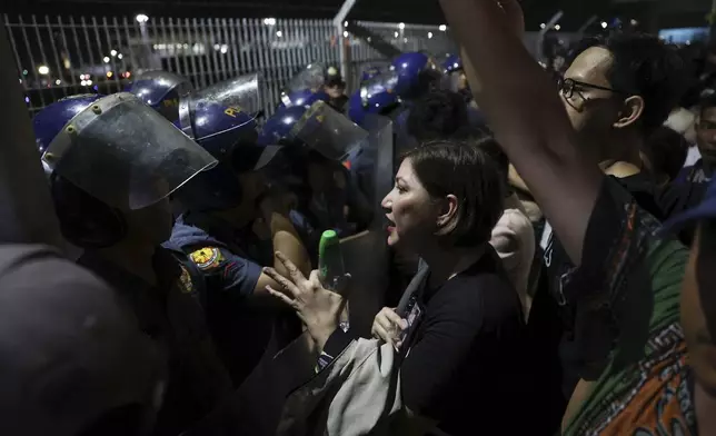 Supporters of former Philippine President Rodrigo Duterte confront police as they gather outside the Villamor Air Base in Manila, Philippines, Tuesday, March 11, 2025. (AP Photo/Basilio Sepe)