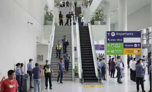 Security officers patrol the airport after former President Rodrigo Duterte was arrested, in Manila, Philippines, Tuesday, March 11, 2025. (AP Photo/Aaron Favila)
