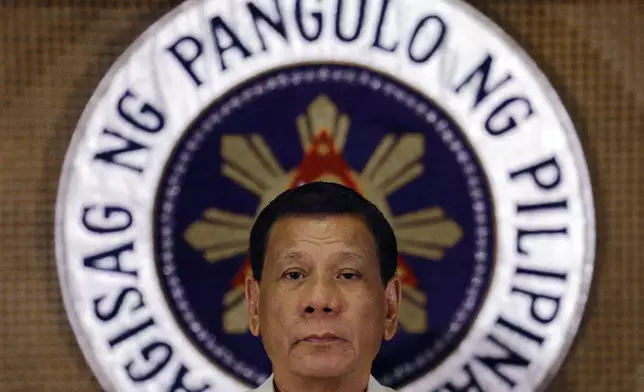 FILE - Philippine President Rodrigo Duterte stands in front of the presidential seal during a ceremony with the Armed Forces of the Philippines at the Malacanang presidential palace in Manila, Philippines on July 18, 2017. (AP Photo/Aaron Favila, File)