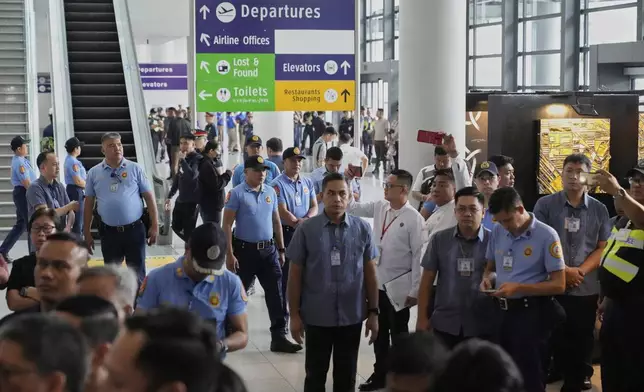 Security officers patrol the airport after former President Rodrigo Duterte was arrested, in Manila, Philippines, Tuesday, March 11, 2025. (AP Photo/Aaron Favila)