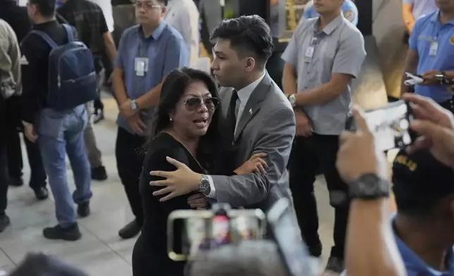 A supporter of former President Rodrigo Duterte reacts upon finding out he was arrested, at the airport in Manila, Philippines, Tuesday, March 11, 2025. (AP Photo/Aaron Favila)