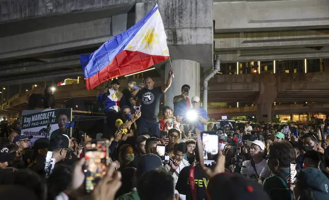 Supporters of former Philippine President Rodrigo Duterte gather outside the Villamor Air Base in Manila, Philippines, Tuesday, March 11, 2025. (AP Photo/Basilio Sepe)