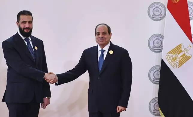In this photo provided by Egypt's presidency media office, Egyptian President Abdel-Fattah el-Sissi, greets Syria's interim President Ahmad al-Sharaa during the emergency Arab summit at Egypt's New Administrative Capital, just outside Cairo, Tuesday, March 4, 2025. (Egyptian Presidency Media Office via AP)