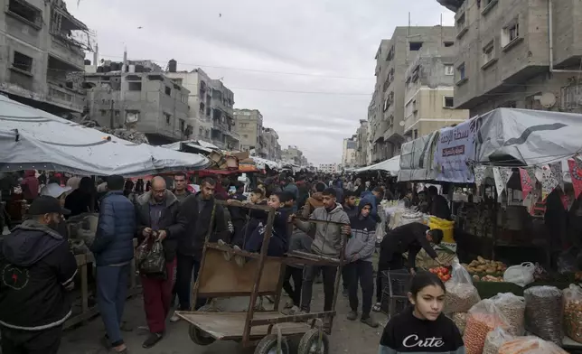 Palestinians shop at Sheikh Radwan Market, west of Gaza City, before the Iftar, the fast-breaking meal, during the holy month of Ramadan on Monday, March 3, 2025. (AP Photo/Jehad Alshrafi)