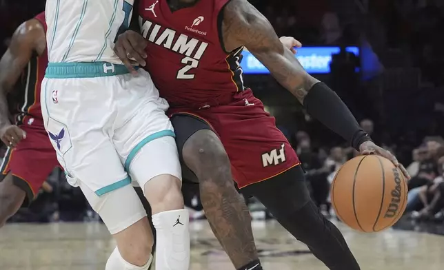 Charlotte Hornets guard LaMelo Ball (1) defends Miami Heat guard Terry Rozier (2) during the first half of an NBA basketball game, Monday, March 10, 2025, in Miami. (AP Photo/Marta Lavandier)