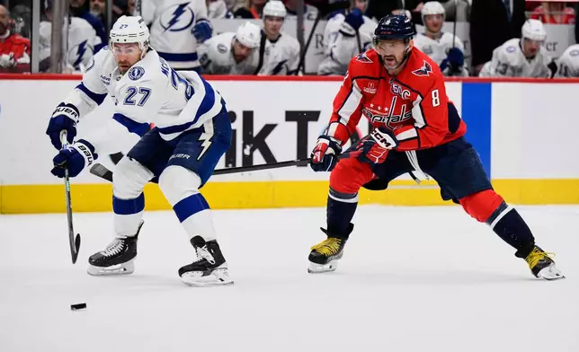 Tampa Bay Lightning defenseman Ryan McDonagh (27) and Washington Capitals left wing Alex Ovechkin (8) skate after the puck during the first period of an NHL hockey game, Saturday, March 1, 2025, in Washington. (AP Photo/Nick Wass)