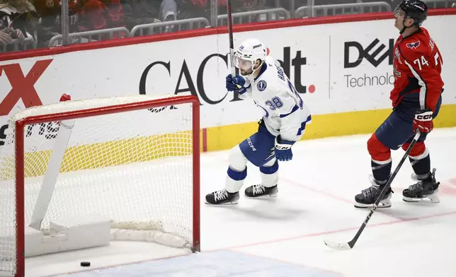 Tampa Bay Lightning left wing Brandon Hagel (38) reacts to his empty net goal as he skates by Washington Capitals defenseman John Carlson (74) during the third period of an NHL hockey game, Saturday, March 1, 2025, in Washington. (AP Photo/Nick Wass)