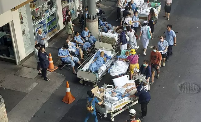 Patients are evacuated outdoors at a hospital after a 7.7 magnitude earthquake in Bangkok, Thailand, Friday, March 28, 2025. (AP Photo/Tadchakorn Kitchaiphon)