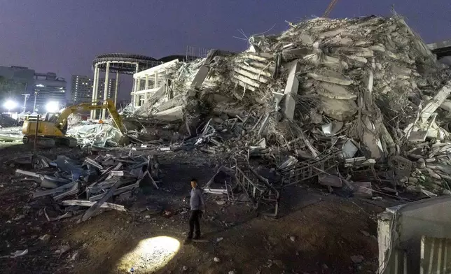 Rescuers search for victims at the site of a high-rise building under construction that collapsed after a strong earthquake in Bangkok, Thailand, early Saturday, March 29, 2025. (AP Photo/Wason Wanichakorn)