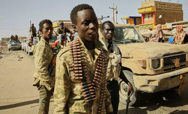 CORRECTS COUNTRY TO SUDAN, NOT SYRIA Soldiers arrive to the Allafah market, in an area recently recaptured by Sudan's army from the Rapid Support Forces paramilitary group, in the Al Kalalah district, 40km south of Khartoum, Sudan, Thursday March 27, 2025. (AP Photo)