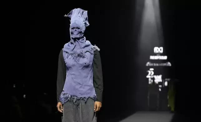 A model presents creations by Anurag Gupta during the Fashion Design Council of India (FDCI) Lakme Fashion Week (LFW) in Mumbai, India, Thursday, March 27, 2025.(AP Photo/Rajanish Kakade)