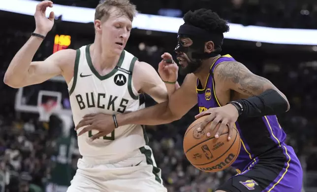 Los Angeles Lakers' Jordan Goodwin tries to get past Milwaukee Bucks' AJ Green during the first half of an NBA basketball game Thursday, Mar. 13, 2025, in Milwaukee. (AP Photo/Morry Gash)