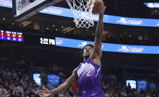 Utah Jazz guard Collin Sexton lays up the ball against the Cleveland Cavaliers during the first half of an NBA basketball game, Sunday, March 23, 2025, in Salt Lake City. (AP Photo/Rob Gray)