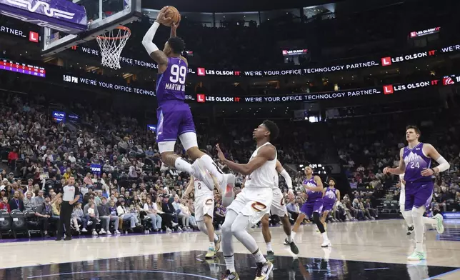 Utah Jazz forward KJ Martin (99) dunks against the Cleveland Cavaliers during the first half of an NBA basketball game, Sunday, March 23, 2025, in Salt Lake City. (AP Photo/Rob Gray)