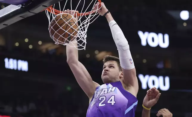 Utah Jazz center Walker Kessler dunks against the Cleveland Cavaliers during the first half of an NBA basketball game, Sunday, March 23, 2025, in Salt Lake City. (AP Photo/Rob Gray)