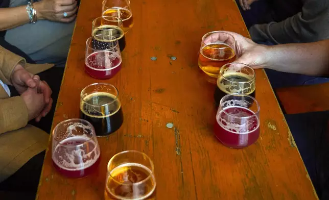 A selection of beers adorn a table in a bar on the Bermondsey Beer Mile in south London, Saturday March 8, 2025. (AP Photo/Tony Hicks)