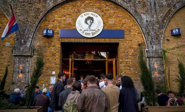 People queue to enter "It ain't much, if it ain't Dutch" Dutch Taproom on the Bermondsey Beer Mile in south London, Saturday March 8, 2025. (AP Photo/Tony Hicks)