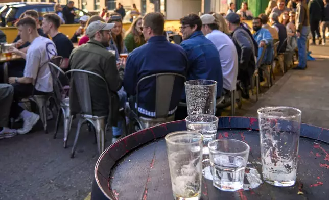 Empty glasses are placed on a barrel outside the Hiver Beers bar and brewery on the Bermondsey Beer Mile in south London, Saturday March 8, 2025. (AP Photo/Tony Hicks)