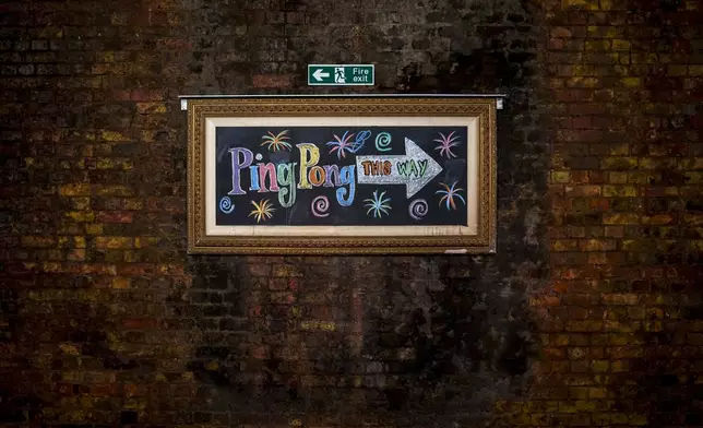 A sign directing people to the Ping Pong tables inside The Doodle Bar on the Bermondsey Beer Mile in south London, Saturday March 8, 2025. (AP Photo/Tony Hicks)