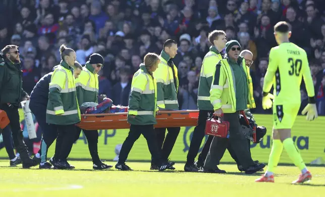 Crystal Palace's Jean-Philippe Mateta is substituted off on a stretcher during the English FA Cup soccer match between Crystal Palace and Millwall at Selhurst Park, London, England, Saturday, March 1, 2025. (AP Photo/Ian Walton)