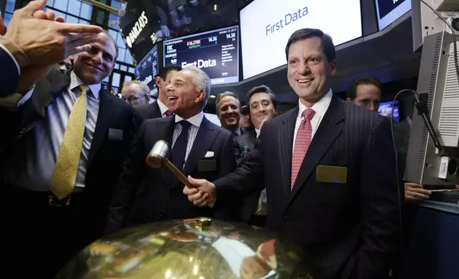 FILE - Frank Bisignano, right, then Chairman and CEO of First Data, smiles after the company's IPO at the New York Stock Exchange, Oct. 15, 2015. (AP Photo/Richard Drew, File)