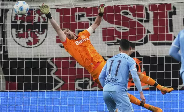 Leverkusen's goalkeeper Lukas Hradecky fails to save the goal during the German Bundesliga soccer match between Bayer Leverkusen and VfL Bochum at the BayArena in Leverkusen, Germany, Friday, March 28, 2025. (AP Photo/Martin Meissner)