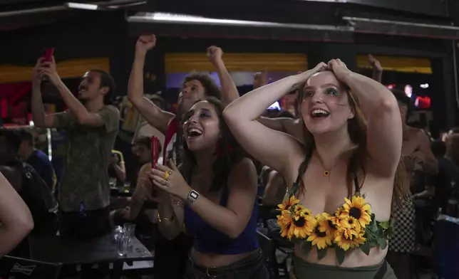 People celebrate upon learning that Brazilian film "I'm Still Here" won the Oscar for best International Feature Film in Sao Paulo, Sunday, March 2, 2025. (AP Photo/Ettore Chiereguini)