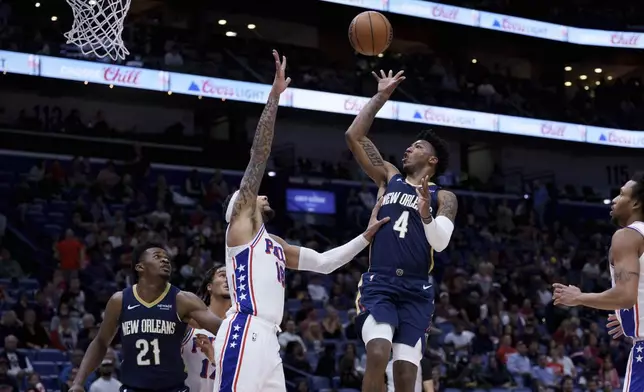 New Orleans Pelicans guard Elfrid Payton (4) shoots against Philadelphia 76ers forward Chuma Okeke (18) during the first half of an NBA basketball game in New Orleans, Monday, March 24, 2025. (AP Photo/Matthew Hinton)