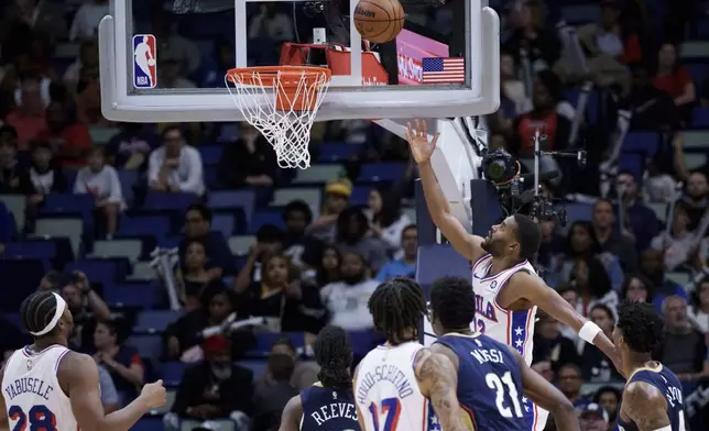 Philadelphia 76ers guard Jared Butler (12) makes a basket against the New Orleans Pelicans during the first half of an NBA basketball game in New Orleans, Monday, March 24, 2025. (AP Photo/Matthew Hinton)