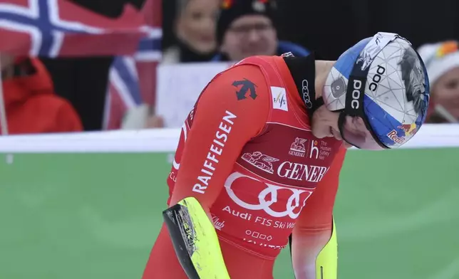 Switzerland's Marco Odermatt reacts after completing an alpine ski, men's World Cup downhill, in Kvitfjell, Norway, Saturday, March 8, 2025. (AP Photo/Marco Trovati)