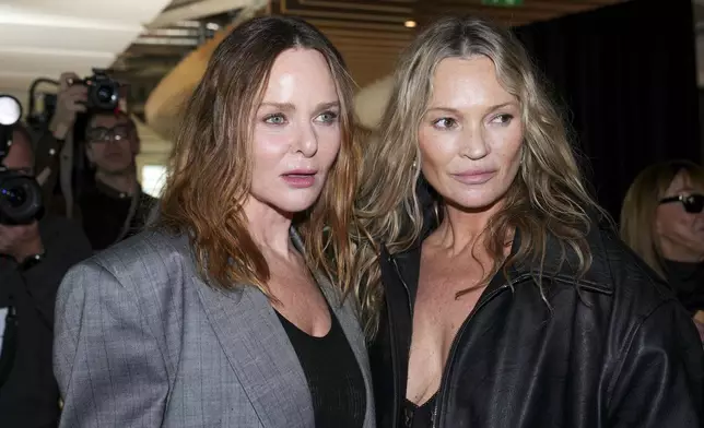 Designer Stella McCartney, left, and Kate Moss backstage after the Stella McCartney Fall/Winter 2025-2026 Womenswear collection presented in Paris, Wednesday, March 5, 2025. (Photo by Scott A Garfitt/Invision/AP)