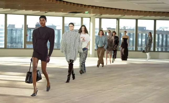 Models wear creations as part of the Stella Mccartney Fall/Winter 2025-2026 Womenswear collection presented in Paris, Wednesday, March 5, 2025. (Photo by Scott A Garfitt/Invision/AP)