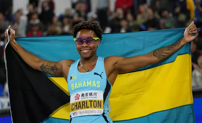 Devine Charlton, of Bahamas, celebrates after winning gold in the women's 60 meter hurdles at the the World Athletics Indoor Championships in Nanjing, China, Sunday, March 23, 2025. (AP Photo/Dar Yasin)