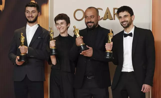 Basel Adra, from left, Rachel Szor, Hamdan Ballal, and Yuval Abraham, winners of the award for best documentary feature film for "No Other Land," pose in the press room at the Oscars on Sunday, March 2, 2025, at the Dolby Theatre in Los Angeles. (Photo by Jordan Strauss/Invision/AP)