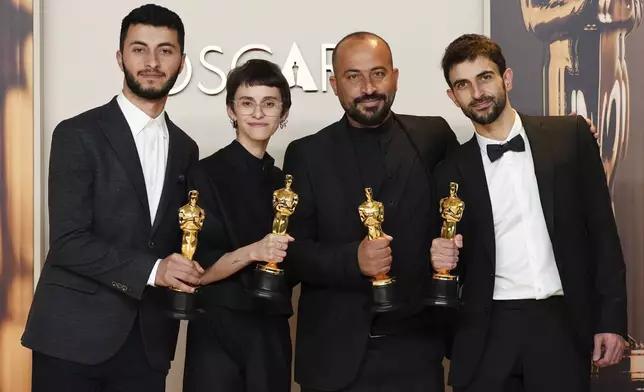 Basel Adra, from left, Rachel Szor, Hamdan Ballal, and Yuval Abraham, winners of the award for best documentary feature film for "No Other Land," pose in the press room at the Oscars on Sunday, March 2, 2025, at the Dolby Theatre in Los Angeles. (Photo by Jordan Strauss/Invision/AP)