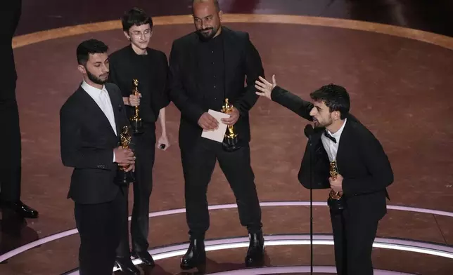 Basel Adra, from left, Rachel Szor, Hamdan Ballal, and Yuval Abraham accept the award for best documentary feature film for "No Other Land" during the Oscars on Sunday, March 2, 2025, at the Dolby Theatre in Los Angeles. (AP Photo/Chris Pizzello)