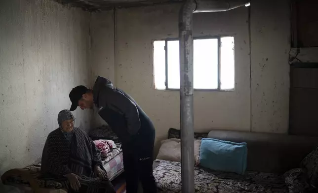 Salem Adra, brother of Palestinian activist Basel Adra, who won Best Documentary Feature at the Oscars for "No Other Land", talks to his grandmother Sarah, 87, at her house in the West Bank village of Tuwani, Monday, March 3, 2025. (AP Photo/Leo Correa)