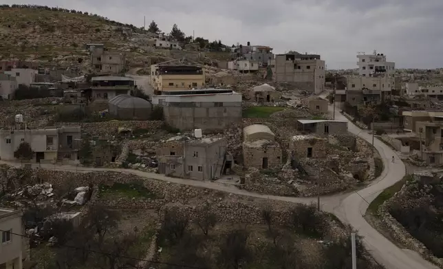 A Palestinian girl walks on a road in the West Bank village of Tuwani, Monday, March 3, 2025. (AP Photo/Leo Correa)