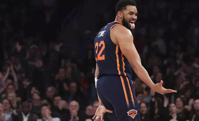 New York Knicks center Karl-Anthony Towns reacts after scoring a 3-point basket during the first half of an NBA basketball game against the Miami Heat, Monday, March 17, 2025, in New York. (AP Photo/Heather Khalifa)