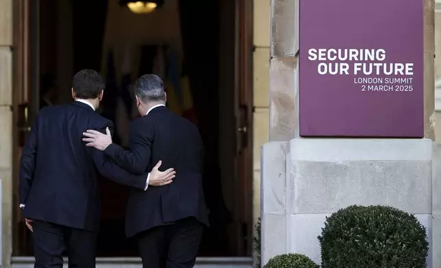 Britain's Prime Minister Keir Starmer, right, welcomes French President Emmanuel Macron to the European leaders' summit to discuss Ukraine, at Lancaster House, London, Sunday March 2, 2025. (Toby Melville/Pool via AP)