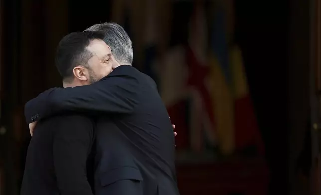 Britain's Prime Minister Keir Starmer, right, welcomes Ukrainian President Volodymyr Zelenskyy to the European leaders' summit to discuss Ukraine, at Lancaster House, London, Sunday March 2, 2025. (Toby Melville/Pool via AP)