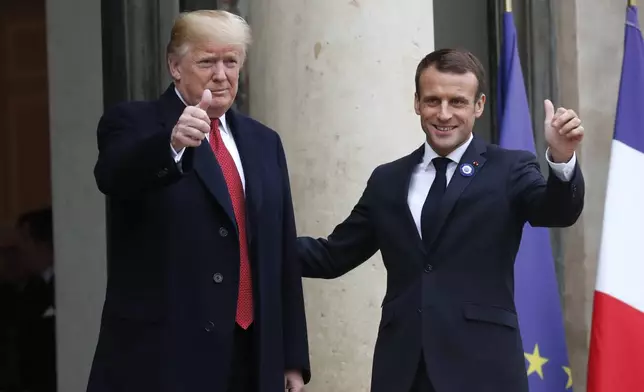 FILE - French President Emmanuel Macron, right, and U.S President Donald Trump thumb up at the Elysee Palace in Paris, Saturday, Nov.10, 2018. (AP Photo/Thibault Camus, File)