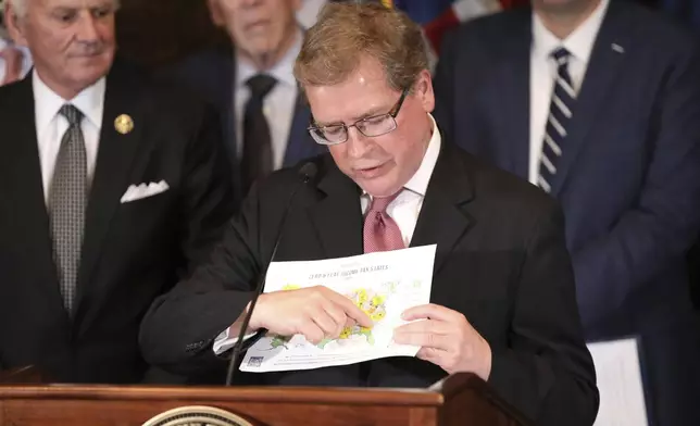 Americans for Tax Reform President Grover Norquist points to South Carolina on a map of states that are passing tax cuts on Tuesday, March 25, 2025, in Columbia, S.C. (AP Photo/Jeffrey Collins)