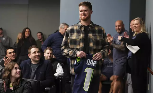 Seattle Seahawks quarterback Sam Darnold arrives for his introductory press conference Thursday, March 13, 2025, at the NFL football team's facilities in Renton, Wash. (AP Photo/Lindsey Wasson)