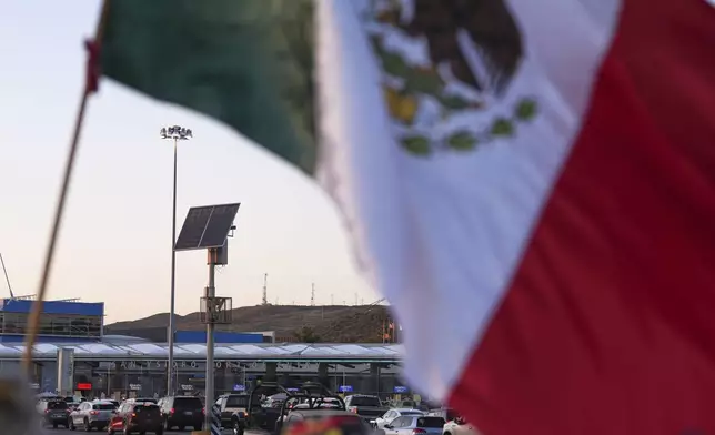 FILE - Vehicles wait in line to cross the border into the United States at the San Ysidro Port of Entry, Tuesday, March 18, 2025, in Tijuana, Mexico. (AP Photo/Gregory Bull, File)