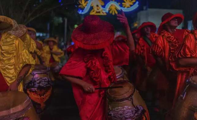 A candombe drummer performs during a Carnival parade in Montevideo, Uruguay, Wednesday, Feb. 19, 2025. (AP Photo/Matilde Campodonico)
