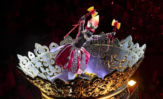 A performer from the Unidos de Padre Miguel samba school dances during Carnival celebrations at the Sambadrome in Rio de Janeiro, Sunday, March 2, 2025. (AP Photo/Bruna Prado)