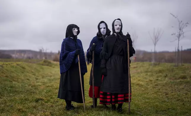Revelers dressed as "Mascaritas" take part in a traditional carnival celebration in the small village of Luzon, Spain, Saturday, March 1, 2025. (AP Photo/Manu Fernandez)