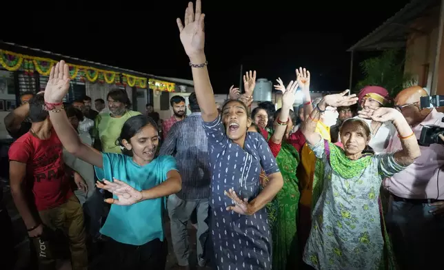 Villagers dance as they celebrate the safe return of NASA astronaut Suni Williams from the International Space Station (ISS), at a temple in her ancestral village Jhulasan in Mehsana district of Gujarat state, India, Wednesday, March 19, 2025. (AP Photo/Ajit Solanki)
