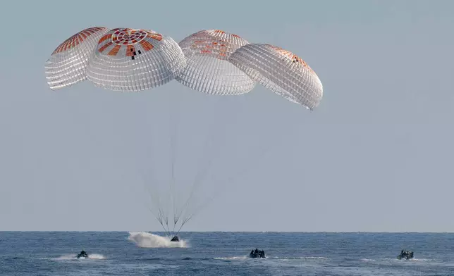 In this image provided by NASA, a SpaceX capsule splashes down in the Gulf of Mexico, Tuesday, March 18, 2025, as it lands off the coast of Florida with NASA astronauts Suni Williams, Butch Wilmore and Nick Hague, and Russian cosmonaut Alexander Gorbunov. (Keegan Barber/NASA via AP)